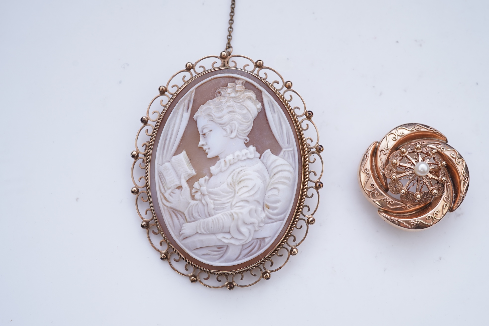 A shell cameo brooch and a gold and cultured pearl brooch